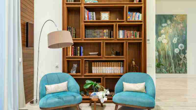 An inviting interior with a modern bookshelf complete with books and teal armchairs for cozy reading., tags: gemütliche leseecken als - pexel
